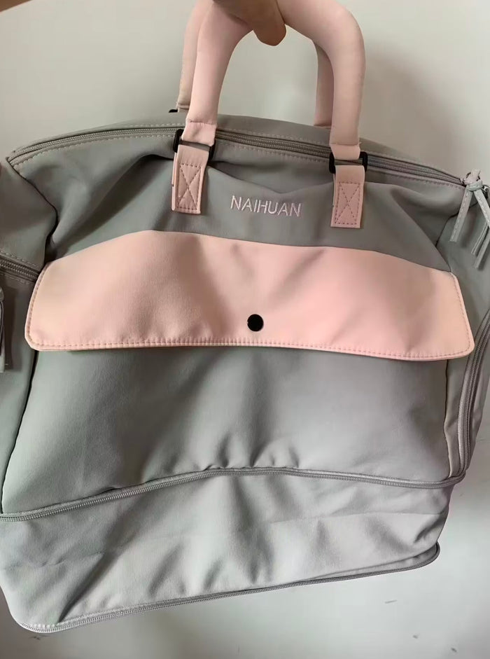 A buyer's photo of the Grey-Pink duffel carried by its padded handles