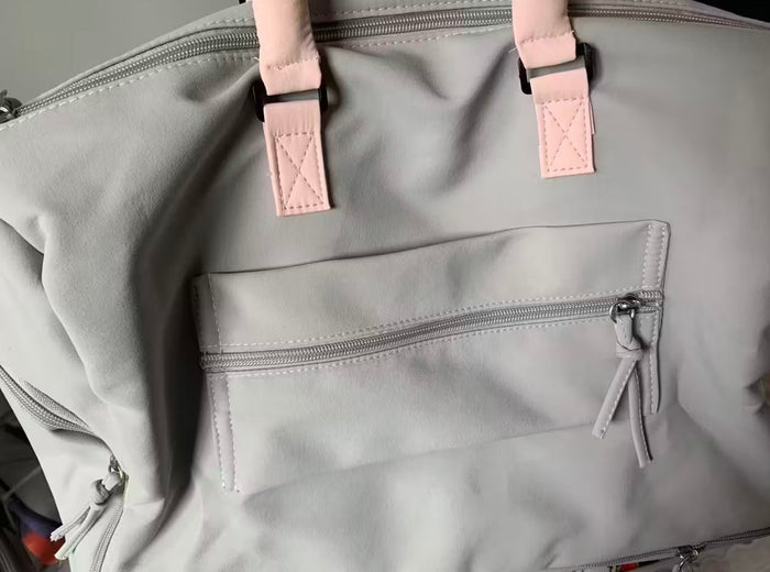 The same buyer's photo of the Grey-Pink duffel, front view