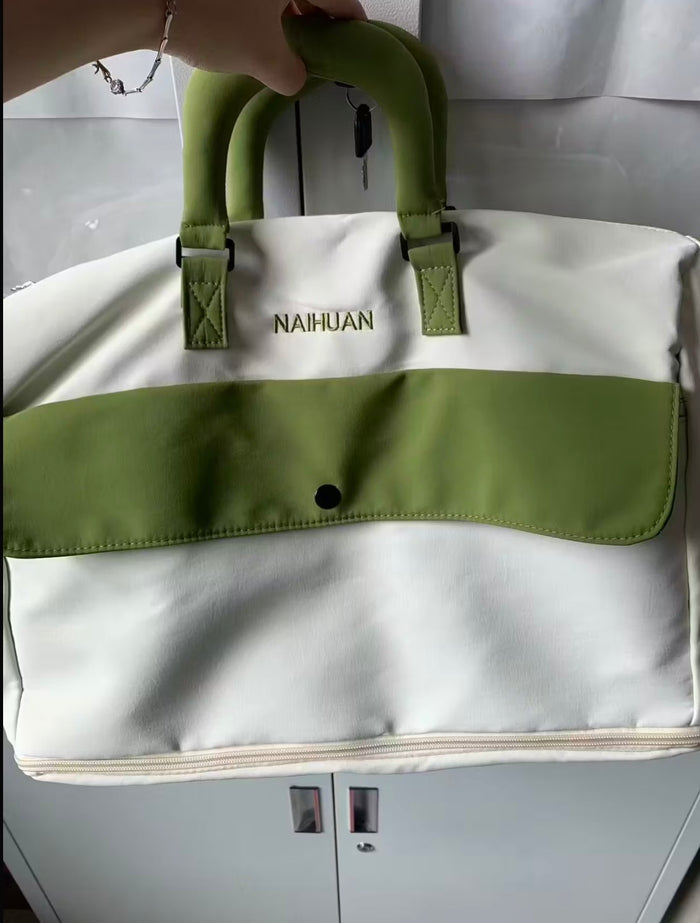 A buyer's photo of the White-Green duffel in front of a cabinet