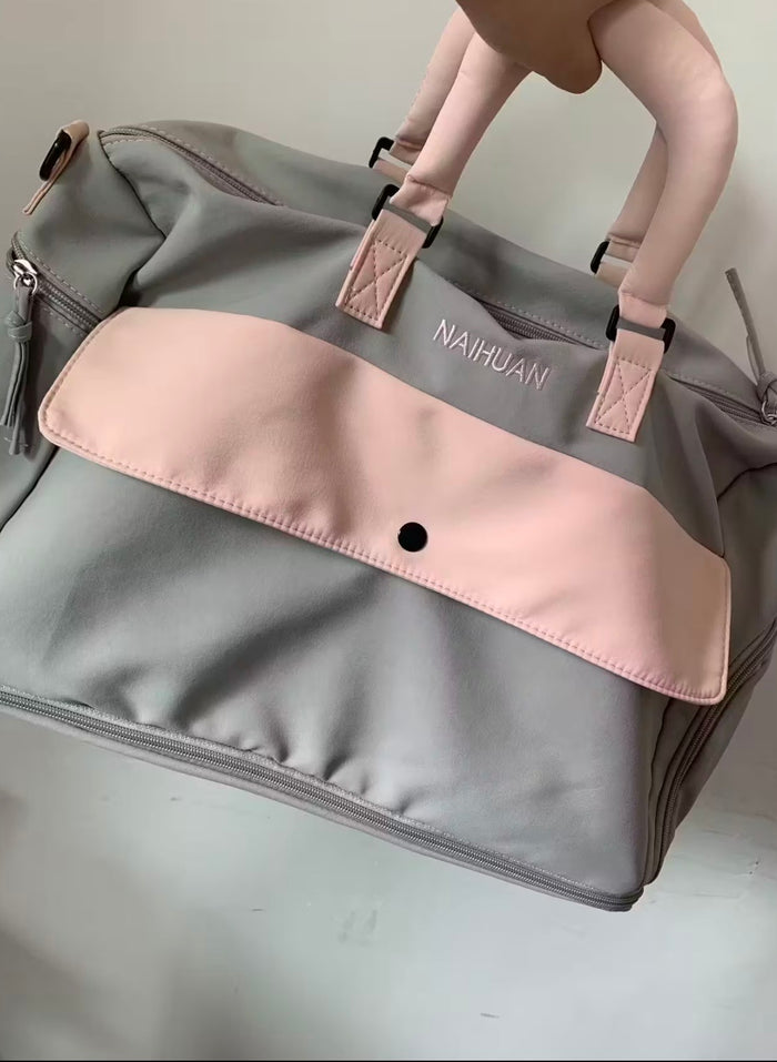 A buyer's photo of the Grey-Pink duffel photographed in a room