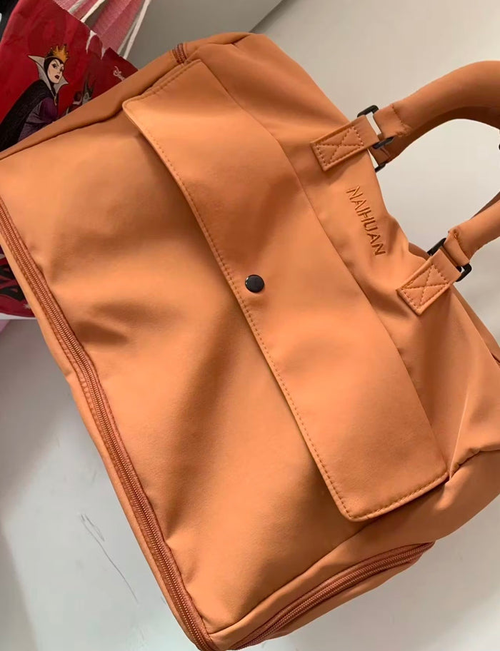 A buyer's photo of the Orange duffel, front view