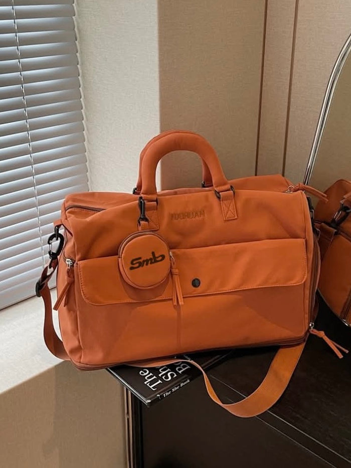 The Orange duffel by a window