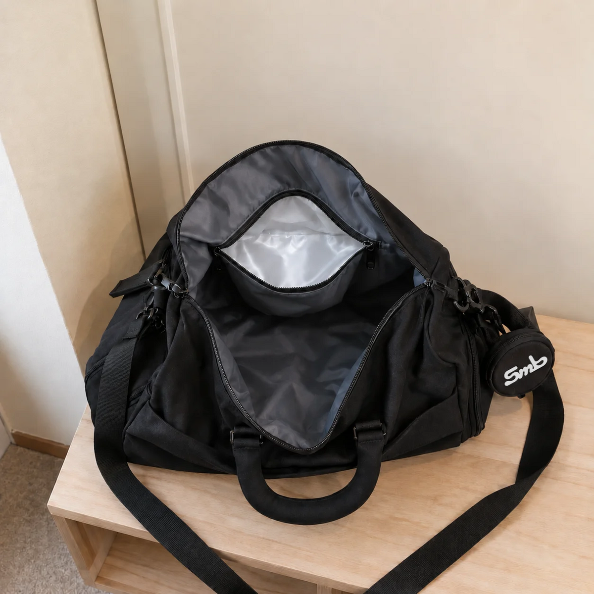 Black — Sports Duffel Bag, looking down into the open main compartment showing the lined interior and internal pockets