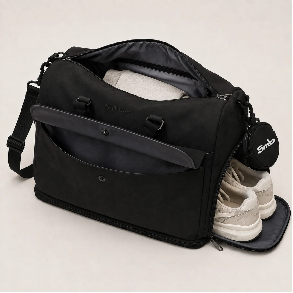 Black — Sports Duffel Bag, main compartment packed and side shoe compartment open with trainers inside