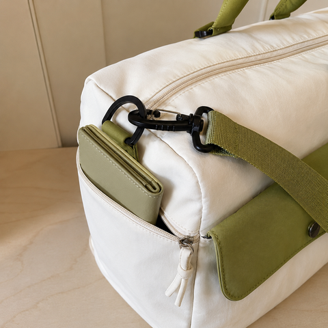 White-Green — Sports Duffel Bag, front flap pocket open with a notebook, wallet and card holder tucked inside