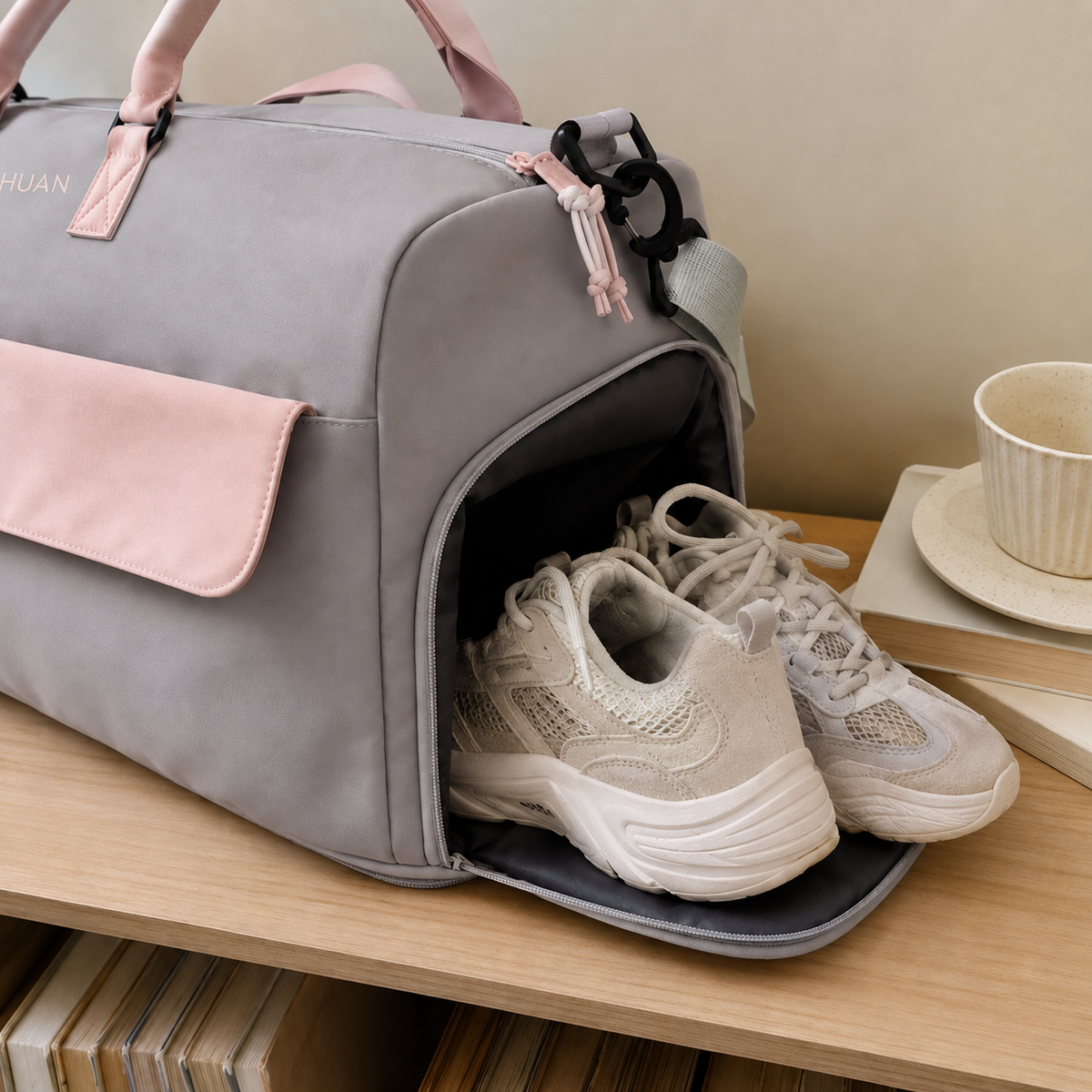 Grey-Pink — Sports Duffel Bag on a shelf, side shoe compartment open with trainers stowed away from the main compartment