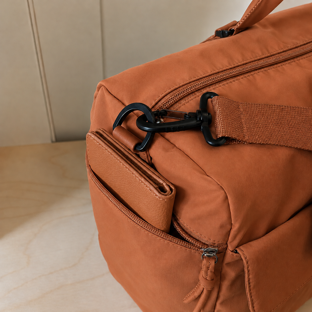 Orange — Sports Duffel Bag, close-up of the snap-front pocket, zip pull and round pouch
