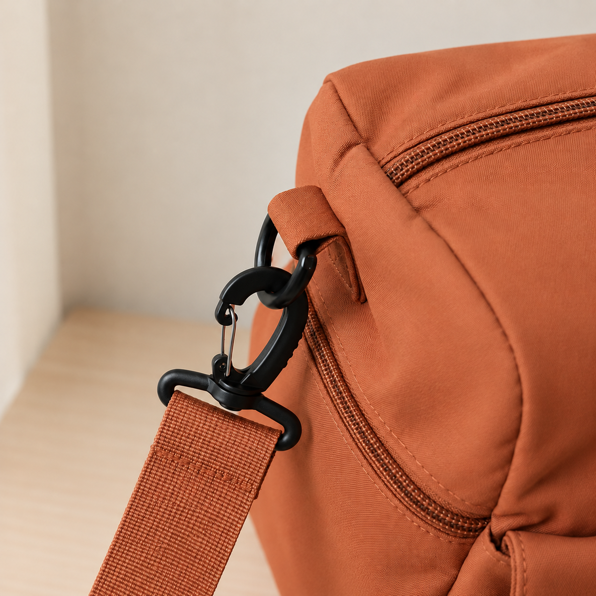 Orange — Sports Duffel Bag, close-up of the webbing shoulder strap and swivel clip